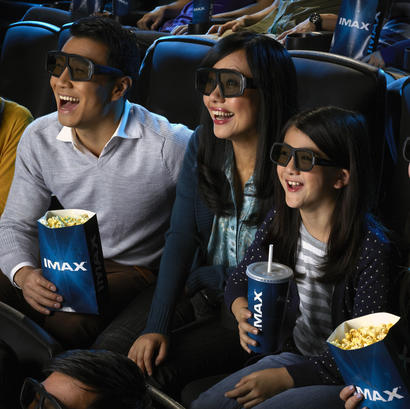 Family with 3D glasses watching IMAX screen