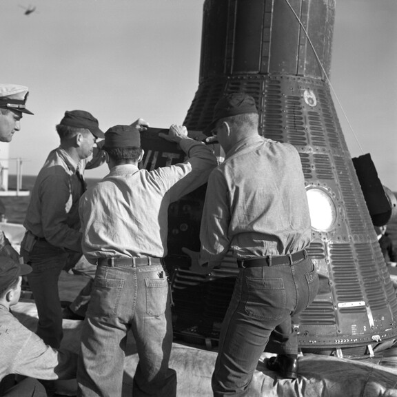 Recovery personnel aboard the USS Donner remove Ham, a 37-pound chimpanzee, from the Mercury-Redstone 2 spacecraft