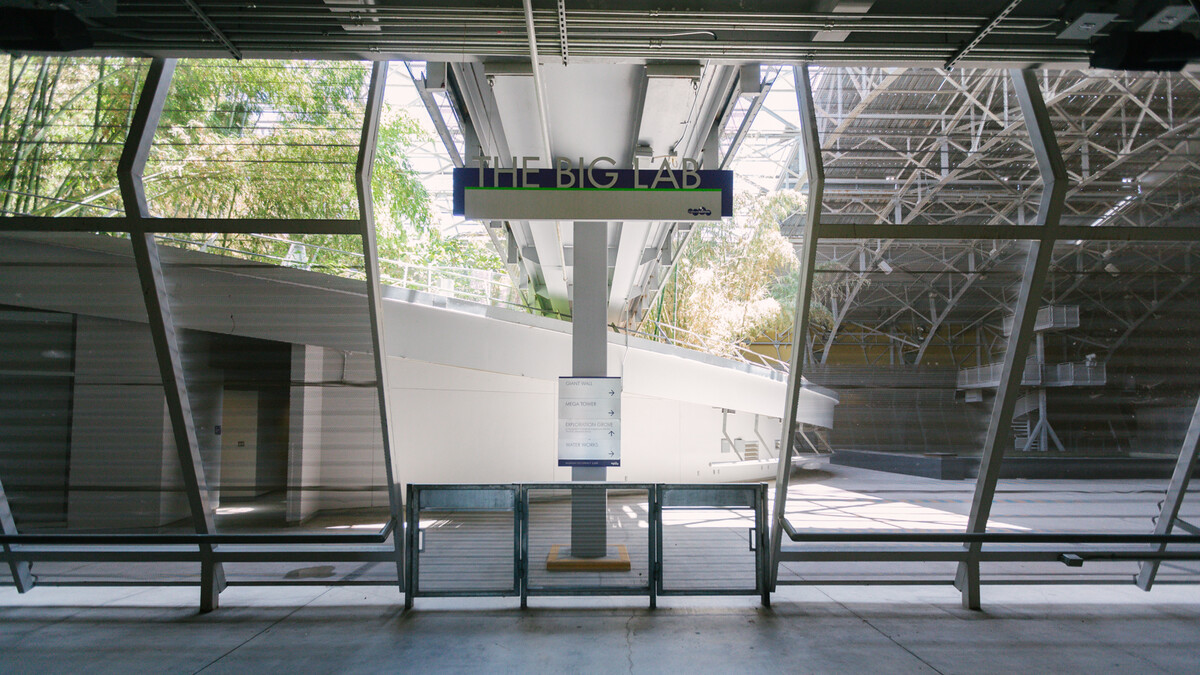 Interior entrance to the Wallis Annenberg Building: Big Lab, featuring corrugated metal walls and gates, and overhead sign with silver lettering which reads "The Big Lab"