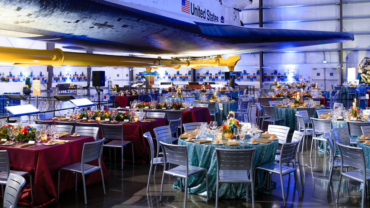 Holiday Dinner Party in the Samuel Oschin Pavilion with metallic teal and red tables