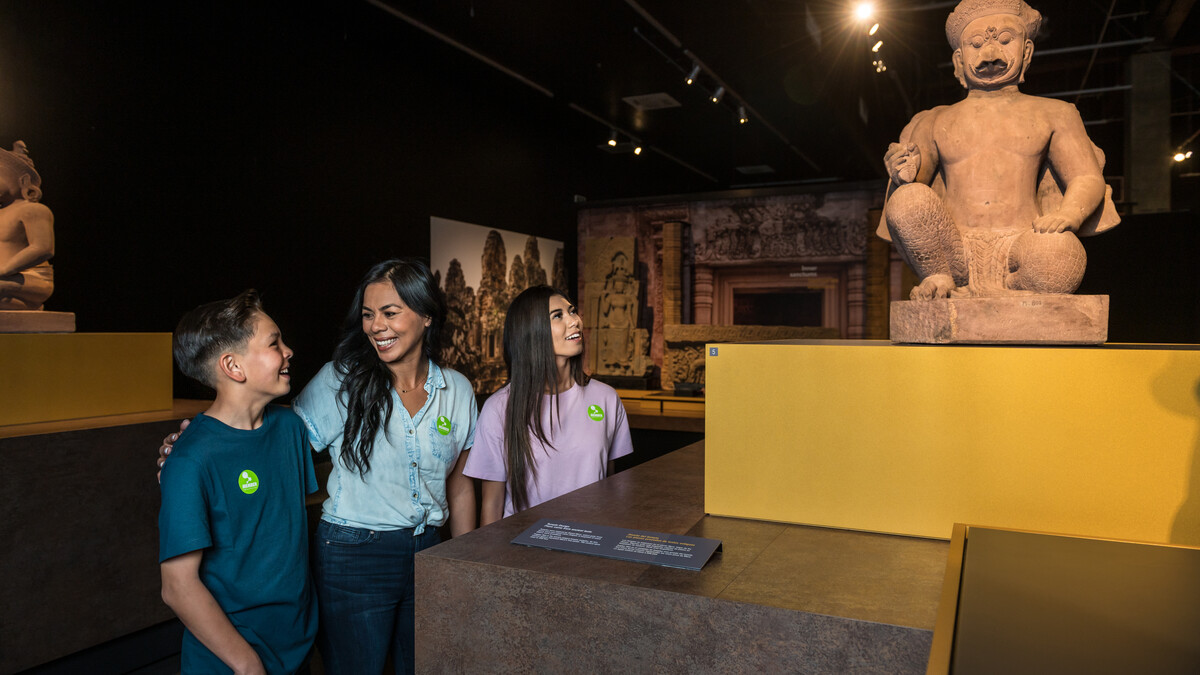 Visitors looking at Garuda Guardian Statue in Ankgor: The Lost Empire of Cambodia Exhibition