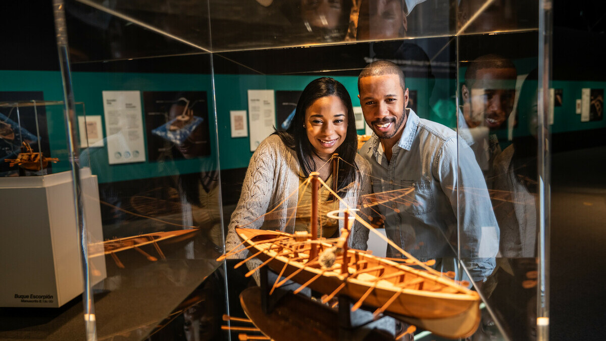 Two guests admire a wooden model of Leonardo da Vinci's row boat inside the da Vinci special exhibition.
