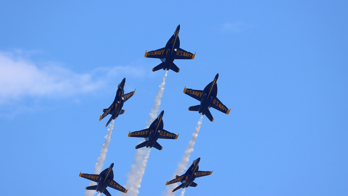 The Blue Angels fly in formation through the sky.