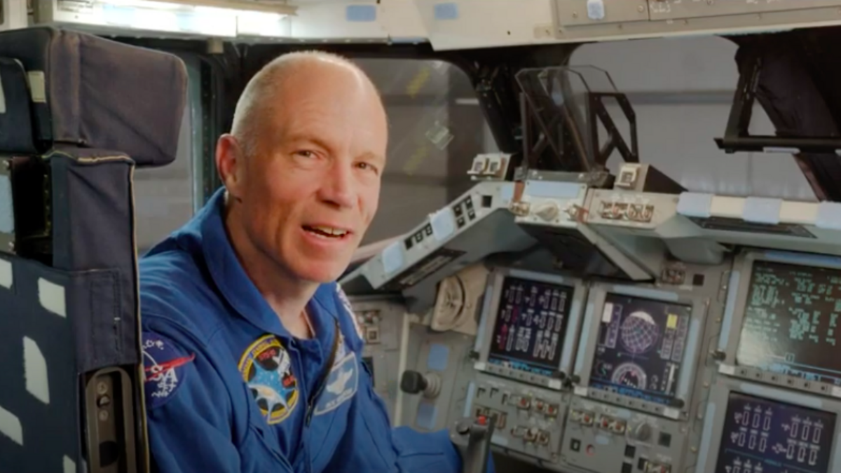 Astronaut Rick Searfoss sitting inside space shuttle Endeavour.
