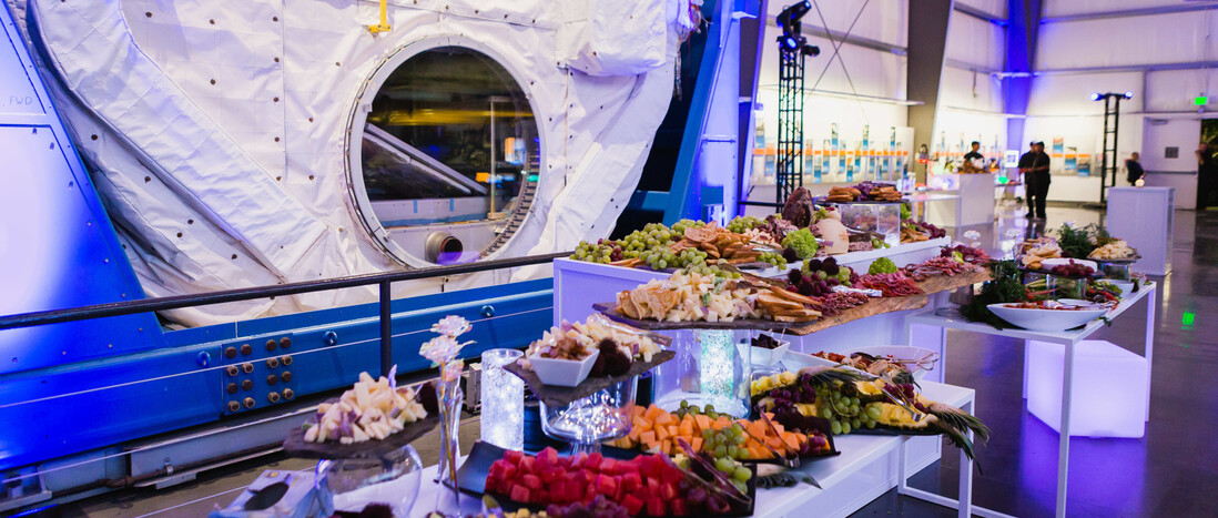 Catering Appetizer buffet of fruits, meats, and cheese in front of SpaceHab in the Samuel Oschin Pavilion